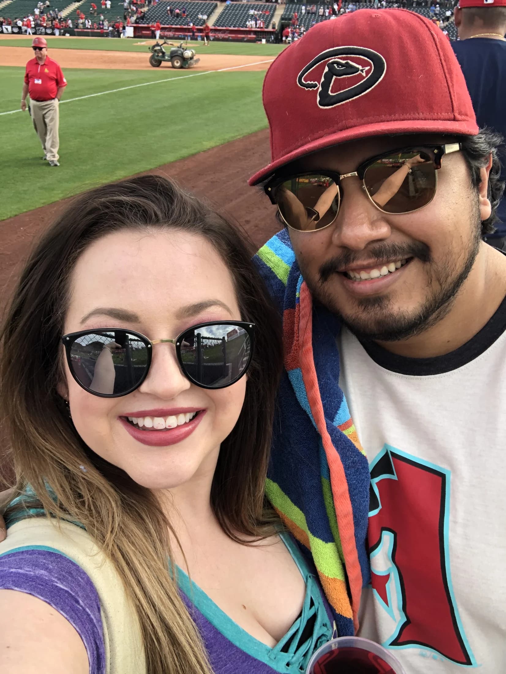 Elena and Vincent taking a selfie at a baseball game