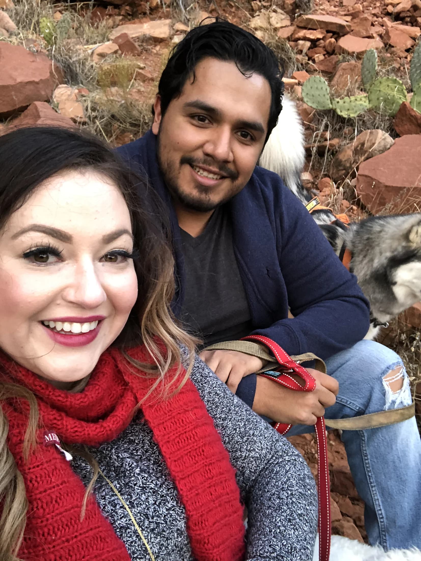 Vincent and Elena out with dogs beside red rocks and a waterfall